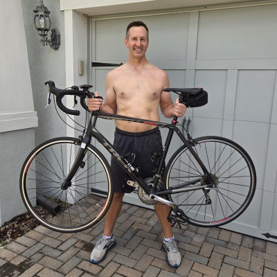 45 year old person holding a bike